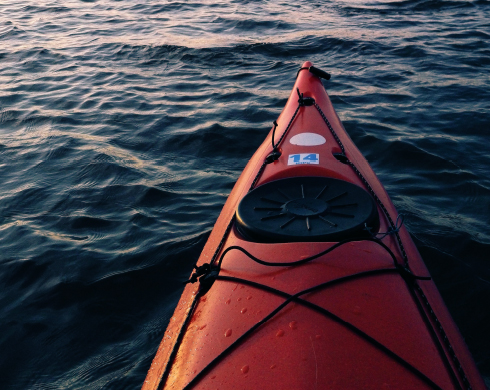 A kayak on water during sunset